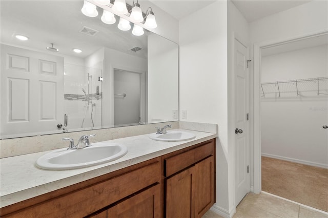 bathroom featuring tile patterned floors, vanity, and an enclosed shower