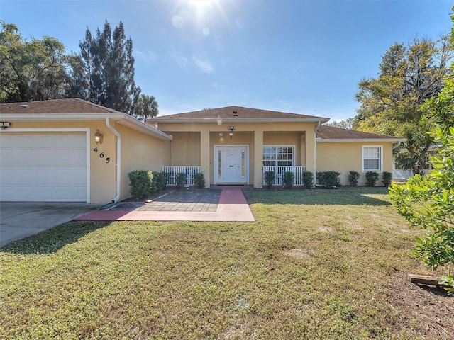 single story home featuring a front lawn, covered porch, and a garage