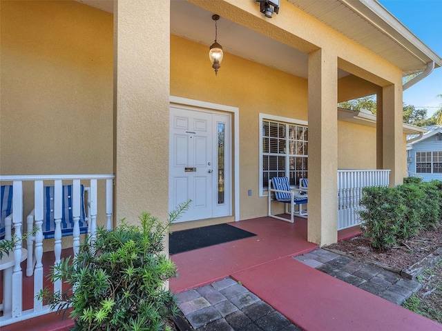 doorway to property featuring covered porch