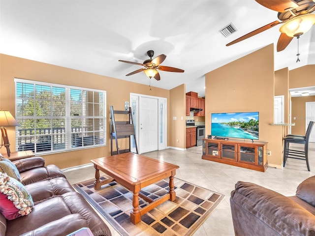 tiled living room featuring ceiling fan and lofted ceiling