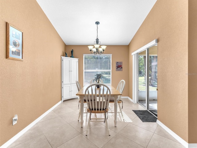 tiled dining area featuring a notable chandelier and vaulted ceiling