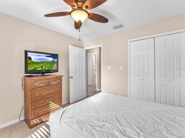 carpeted bedroom featuring ceiling fan and a closet