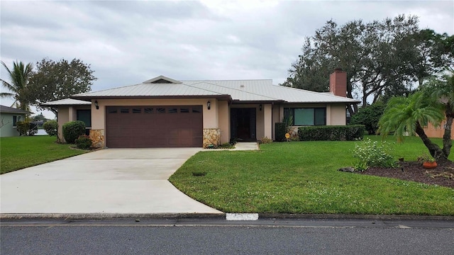 view of front facade with a front yard and a garage