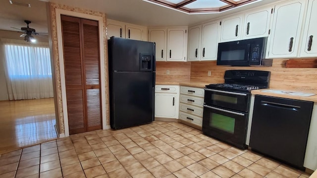 kitchen with black appliances, ceiling fan, white cabinetry, and backsplash