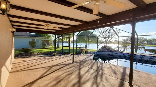 view of patio / terrace featuring a water view, ceiling fan, and a lanai