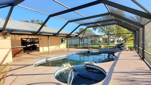 view of pool featuring a patio area, a lanai, and an in ground hot tub