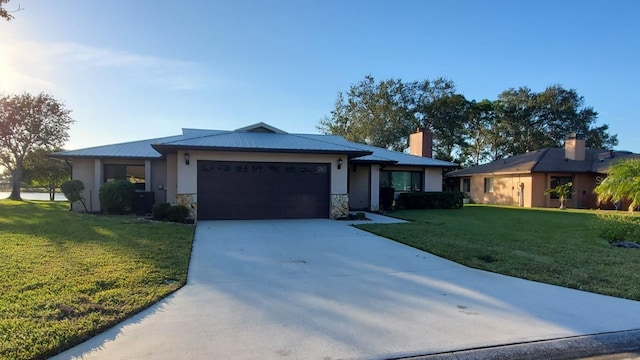 ranch-style house with a garage and a front lawn