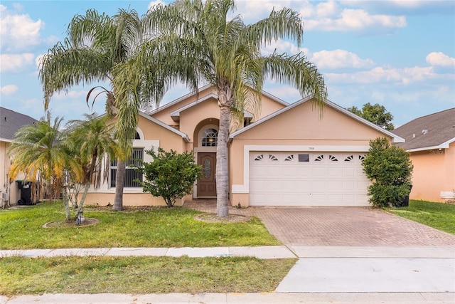 view of front of home featuring a garage and a front lawn