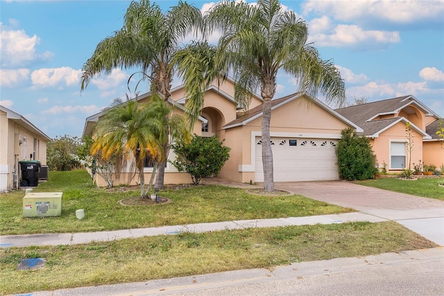 view of front of property with a front yard and a garage