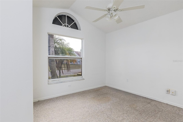 carpeted spare room with lofted ceiling and ceiling fan