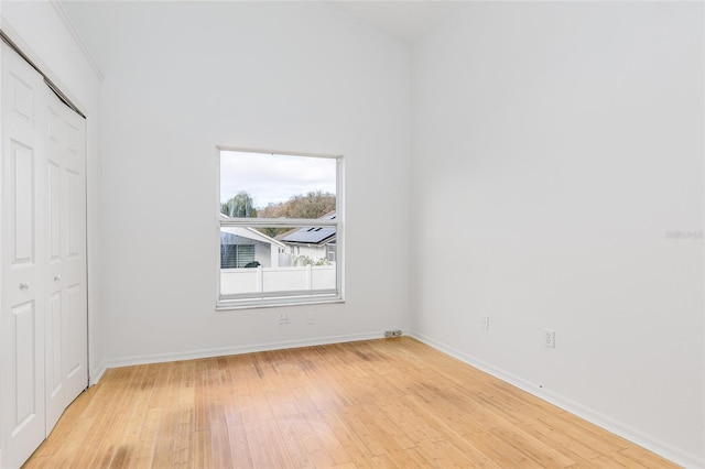 unfurnished bedroom with light hardwood / wood-style floors and a closet