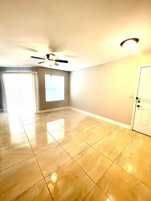 tiled spare room featuring ceiling fan and a textured ceiling