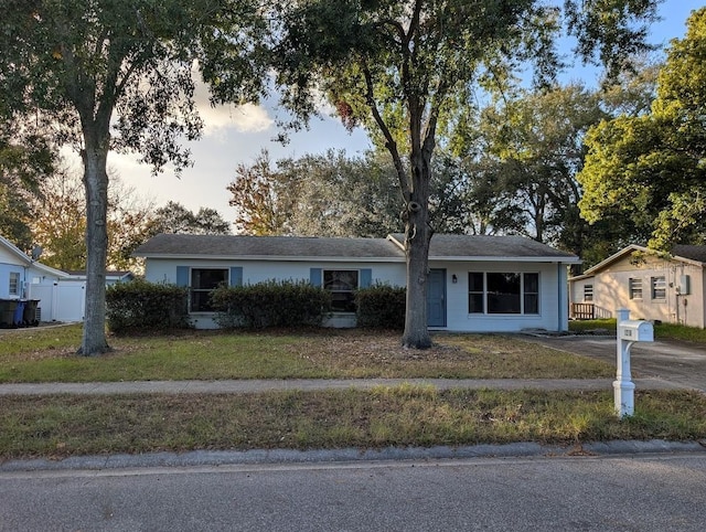 ranch-style home with a lawn