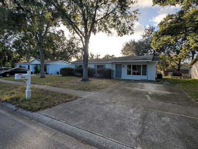 ranch-style home with a front lawn