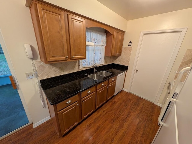 kitchen with dark hardwood / wood-style flooring, backsplash, and sink