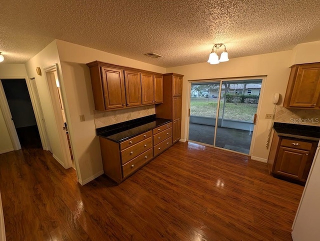 kitchen featuring dark hardwood / wood-style flooring and a textured ceiling