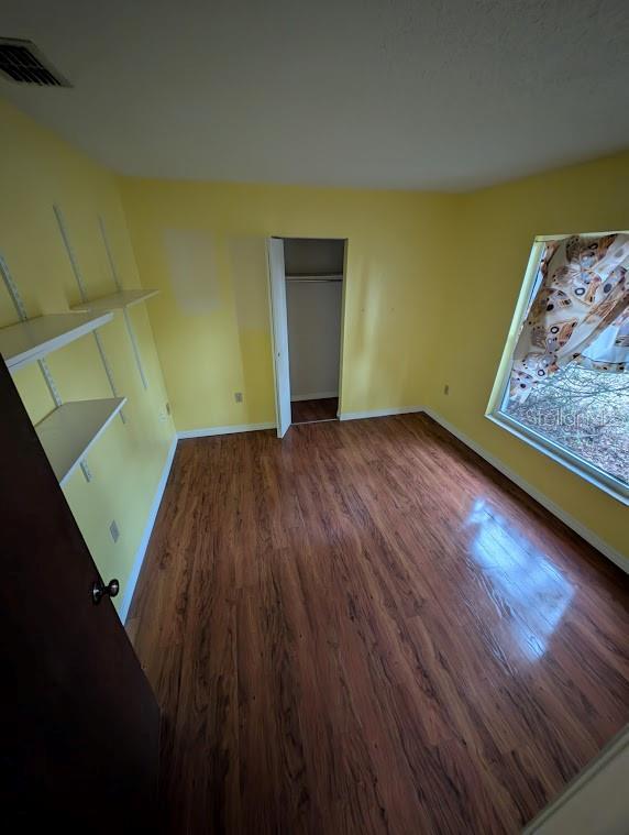 unfurnished room featuring dark hardwood / wood-style floors