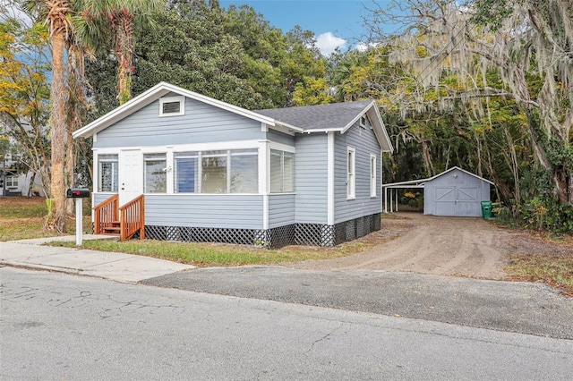 view of front of house with an outbuilding and a carport