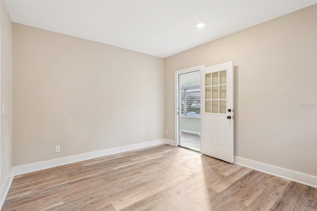 unfurnished room with light wood-type flooring