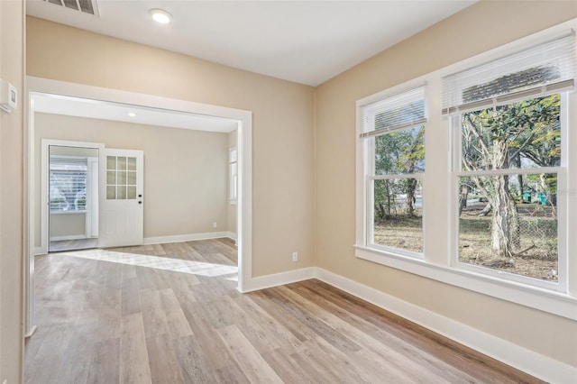 spare room with light wood-type flooring