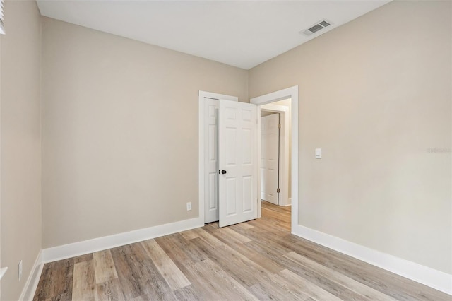 unfurnished room with light wood-type flooring