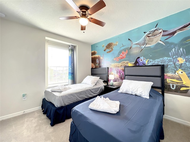 carpeted bedroom with ceiling fan and a textured ceiling