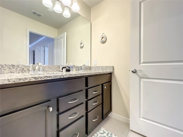 826 Paradise Dr, Davenport, FL 33897 - bathroom featuring double vanity, tile patterned floors, and a chandelier