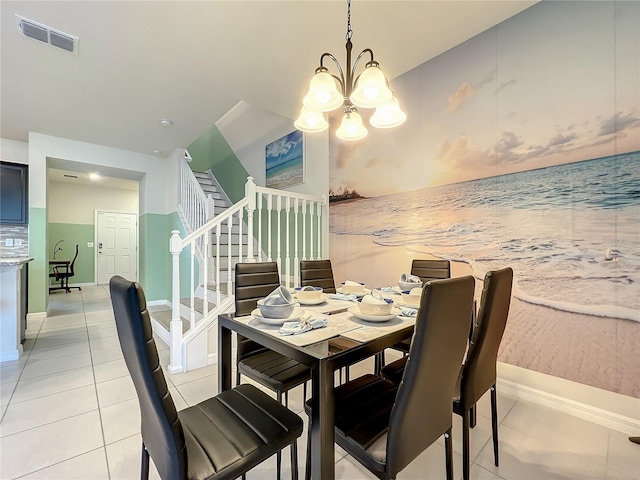 tiled dining room featuring a chandelier