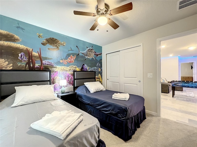 bedroom featuring light carpet, a closet, and ceiling fan