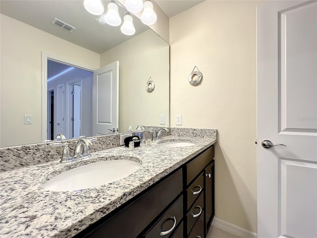 826 Paradise Dr, Davenport, FL 33897 - bathroom featuring double vanity and baseboards