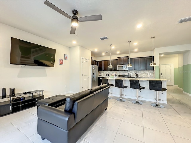 tiled living room with ceiling fan