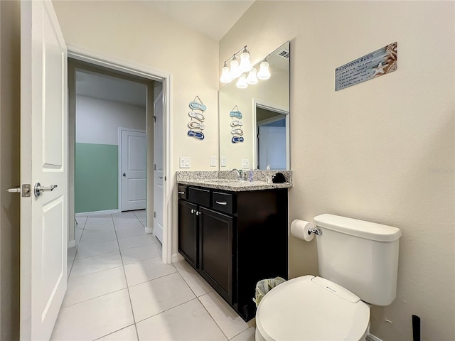 bathroom with tile patterned flooring, vanity, and toilet