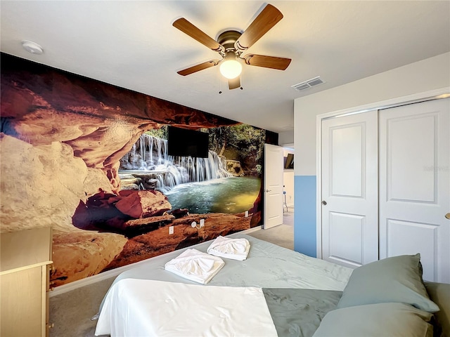 carpeted bedroom with a closet and ceiling fan