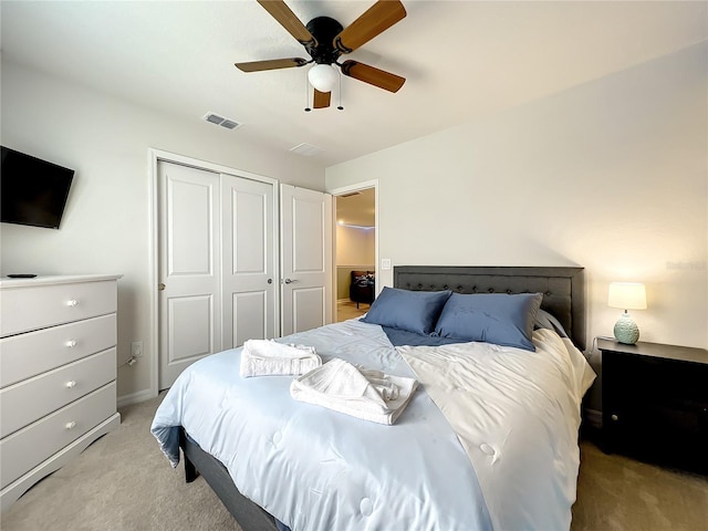 carpeted bedroom featuring ceiling fan and a closet