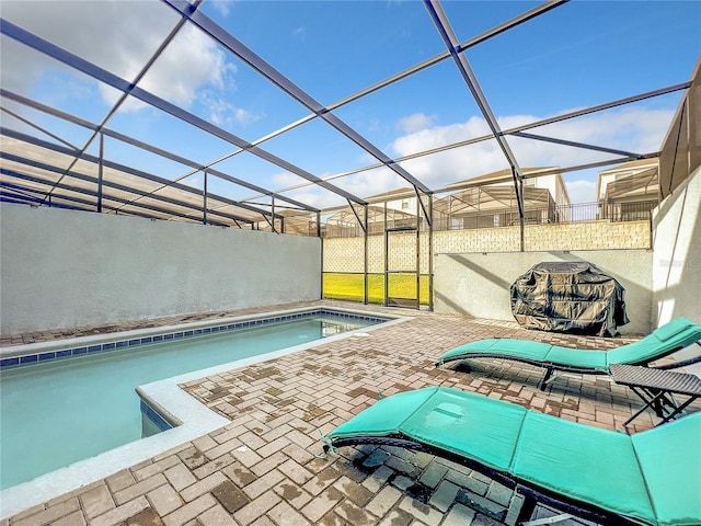 view of swimming pool with a lanai and a patio area