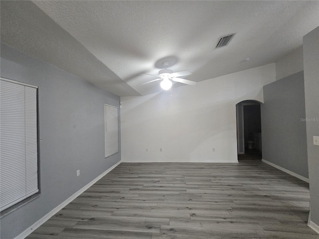 unfurnished room featuring a textured ceiling, ceiling fan, and hardwood / wood-style flooring