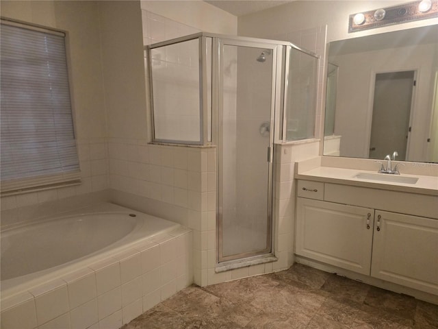 bathroom featuring vanity and independent shower and bath