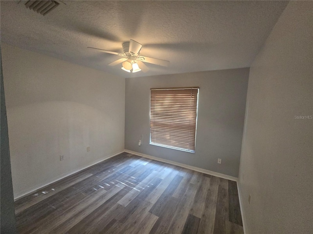 713 Swan Way, Kissimmee, FL 34758 - spare room with a ceiling fan, a textured ceiling, dark wood finished floors, baseboards, and visible vents