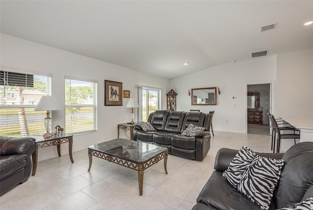 living room with lofted ceiling and light tile patterned floors