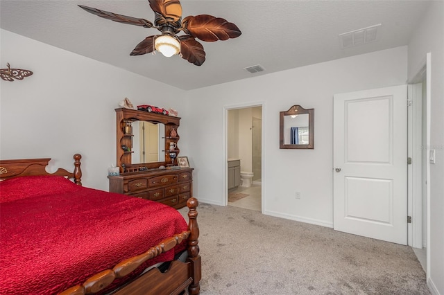 carpeted bedroom featuring ensuite bath and ceiling fan