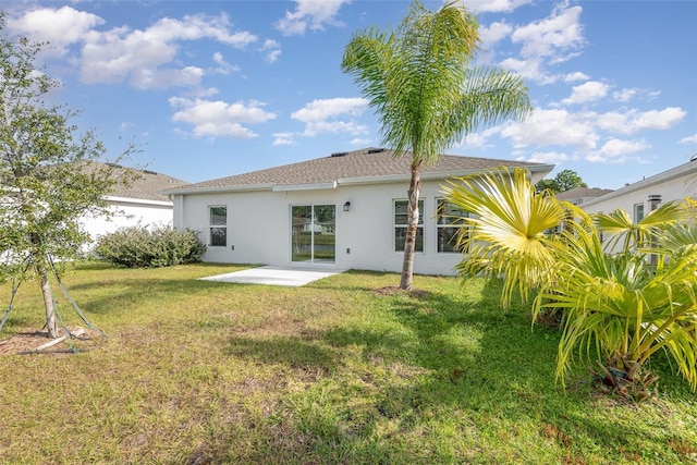 back of property featuring a lawn and a patio