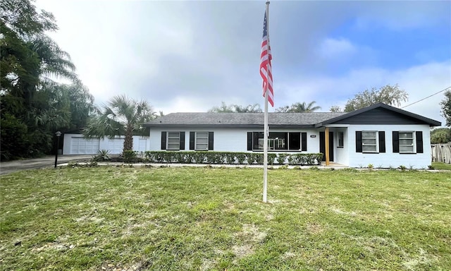 ranch-style home with a garage and a front lawn