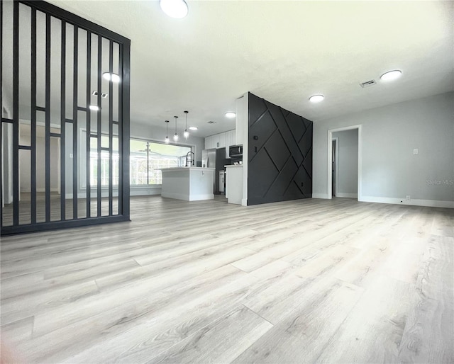 unfurnished living room featuring light hardwood / wood-style flooring