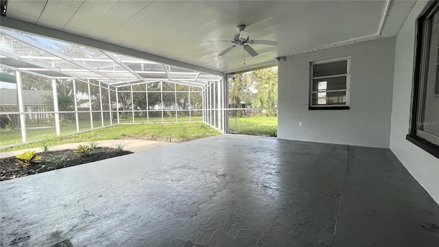 unfurnished sunroom with ceiling fan