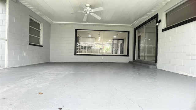 exterior space with ceiling fan and concrete floors