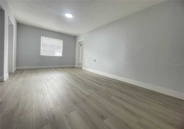 empty room with light hardwood / wood-style floors