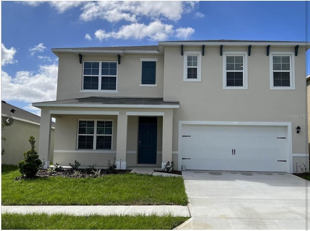 view of front of house with a garage and a front lawn