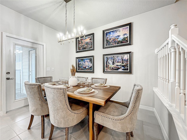 dining area featuring light tile patterned floors, a textured ceiling, and a notable chandelier