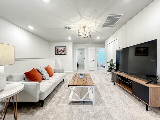 living room featuring a chandelier and light colored carpet