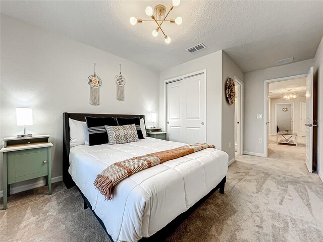 4190 Lana Ave, Davenport, FL 33897 - bedroom with a chandelier, light carpet, a closet, and a textured ceiling